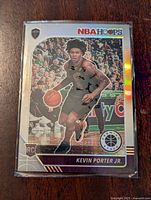 Front of Kevin Porter Jr. rookie card showing player image, team logo, NBA Hoops branding, and rookie card indicator with holographic finish.