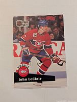 Front view of the 1991-92 Pro Set John LeClair rookie hockey card showing player in Montreal Canadiens uniform on ice.
