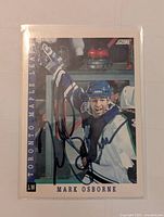 Front of 1993-94 Score Mark Osborne hockey card signed showing autograph and on-ice action photo.