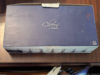 Closed blue box with white text 'Cheers by Mikasa', showing packaging and quantity (8 glasses, 13.5 oz).