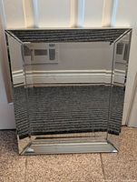 Front view of the rectangular mirror showing its beveled glass frame and reflective surface.