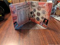 Open view of coin set folder showing 7 coins and Stanley Cup victories list.