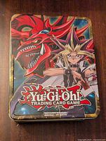 Closed metal tin featuring Slifer the Sky Dragon art and Yugi from Yu-Gi-Oh Trading Card Game