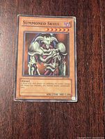 Front view of heavily played Yu-Gi-Oh! Summoned Skull card displaying artwork and card details