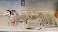 Wide shot of all baking dishes, mixing bowls, and measuring cups on countertop.