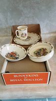 Royal Doulton Bunnykins children’s dinnerware in box showing mug, two plates, two bowls with bunny illustrations