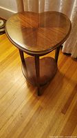 Top view of heart-shaped wooden small table showing polished wood grain finish.