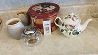 Overall lot with teapots, cream and sugar, and dessert plates box