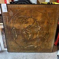 Square framed Piri Reis map artwork with metallic finish and wooden frame, showing detailed embossed figures and symbols.