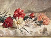Close-up of clusters of red, white and peach carnations on canvas