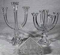 Villeroy & Boch Lucca 3-arm candelabra (left), Towle 5-arm candelabra (right), and crystal napkin holder (front) on a table with floral tablecloth background
