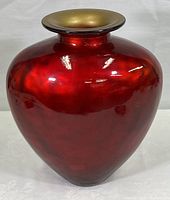 Full view of the metallic red art glass vase showing its bulbous shape and glossy finish.