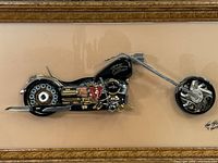 Full view of framed mixed media motorcycle sculpture under glass