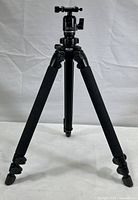 Full view of the black Slik Pro 400DX tripod with foam padded legs extended, showing overall condition and structure.