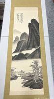 Full view of the vintage Chinese painted scroll showing entire ink landscape and gold brocade mounting