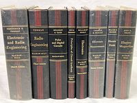 Front spines of eight vintage electrical and radio engineering textbooks shows titles and some authors.