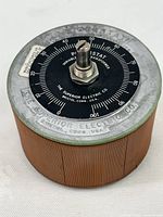 Top view of Powerstat variable autotransformer showing black dial with white numeric scale and central adjustment knob.