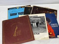 Photo showing six vinyl albums by The Persuasions, Diana Ross, Dakota Staton (including two copies of Alive At Stony Hill), and Sarah Vaughan arranged on a white surface.