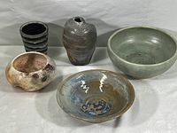 Full set of five handmade ceramic pieces including bowls and vases in various muted and multi-colored glazes