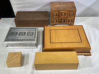 Overview of six decorative keepsake boxes showing various sizes, materials and designs including wood and metal composite boxes.
