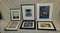 Front view showing all six framed art prints arranged on fabric background