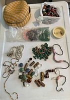 Overview of beads spread on table including bead strands, loose beads, and carrying case