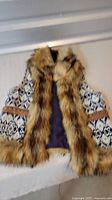 Black and white tapestry vest with brown faux fur collar and trim
