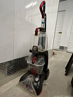 Full view of Hoover Power Scrub Elite Pet upright vacuum cleaner with handle and tanks.