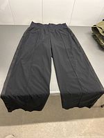 Black women's athletic pants laid flat on table showing front view.