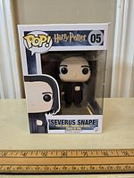 Full view of Funko Pop Harry Potter Severus Snape #05 figure in original box with front and sides visible.