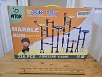Front box of the WTOR Toy 216 piece Marble Run set showing assembled example and branding