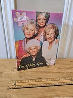 Front view of the sealed puzzle box showing image of four characters from The Golden Girls and 1000-piece label.