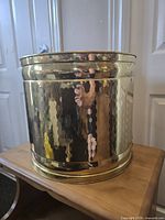 Front angled view showing hammered brass texture and rim detail.