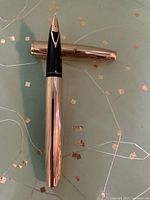 Closed Sheaffer 585 gold-plated fountain pen showing nib and cap.