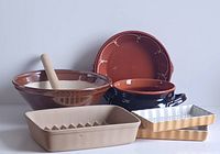 Photo of the full set showing various ceramic and terracotta kitchenware including a suribachi and surikogi, pie plate, terracotta pot, ridged baker, and tart pans.