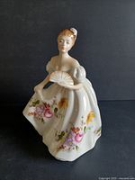 Front view of Royal Doulton Marilyn figurine showing facial detail and fan in hand