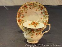 Royal Albert teacup and matching saucer viewed frontally showing floral pattern