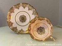 Top view of matching vintage Paragon teacup and saucer showing gold pattern details and pink background.