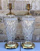 Front view of both lamps side by side showing crystal bodies, brass bases, harps and sockets