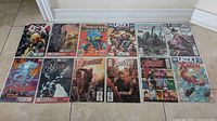 Lot of 12 Marvel comic books laid out on floor, all in plastic covers, featuring Power Man and Iron Fist, Avengers, Daredevil, X-Men