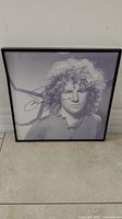 Full view of framed Sammy Roy Hagar autographed photo standing against a wall.