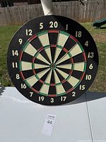 Full view of the full dart board showing whole surface with numbers and colored scoring sections.