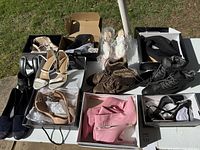 Top view of the entire assortment of women's shoes showing multiple pairs in various styles and colors including heels, boots, and sandals, with some still in boxes.