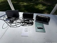 Lot items displayed on table including Nintendo Switch dock, charging adapter, JBL speaker, 3 pairs of 3D glasses, and instruction card.