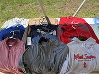 Photo showing a collection of men's hoodies, sweatshirts, and pullovers in various colors and brands including Nike, Under Armour and a St. Louis Cardinals World Series sweatshirt.