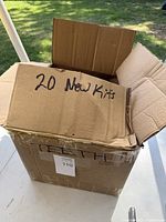 Closed cardboard box labeled '20 New Kits' indicating quantity and condition.