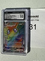 Front side close-up showing holographic Victini VMAX Pokémon card in Japanese, graded CGC Gem Mint 10 with set details.