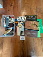 Complete overview of calligraphy set showing pens, ink cartridges, ink bottles, and multiple instructional books.