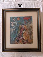 Full framed print showing Marc Chagall's artwork 'La vie au village' with visible mat and frame