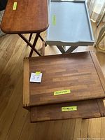 Two TV trays and two wooden nesting tables shown from above and front angles, with handwritten size labels visible on the tables.